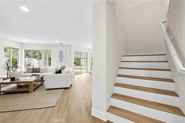 a living room with furniture kitchen view and a table