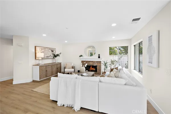 a view of a dining room with furniture large windows and wooden floor