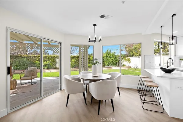 a large white kitchen with a stove top oven sink and cabinets