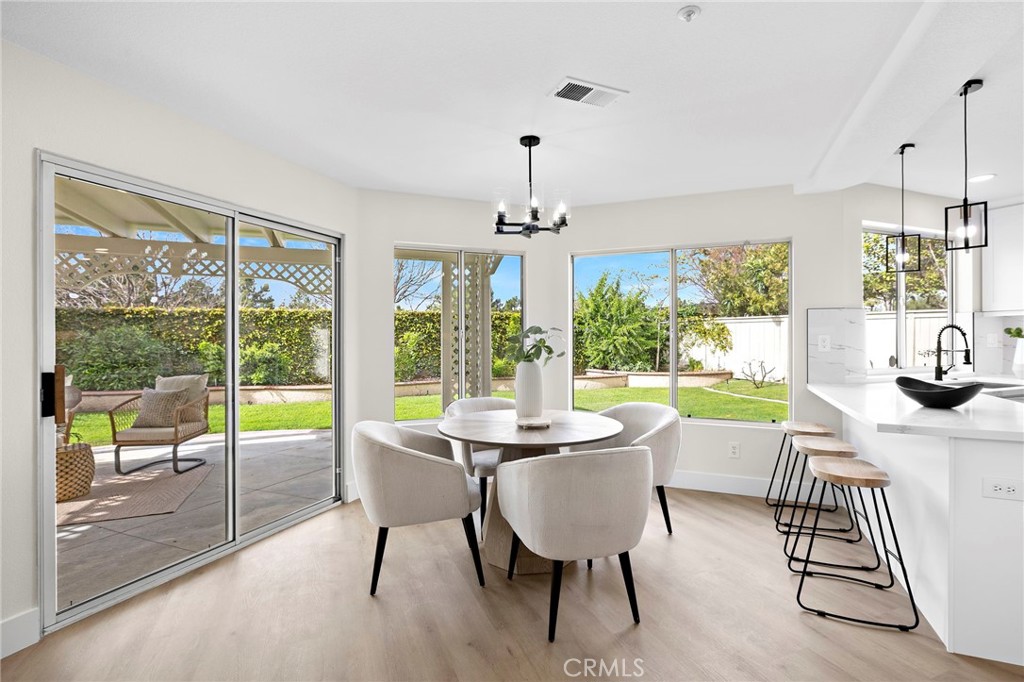 17 Rhode Island Irvine, CA 92606 - Photo 21 of 62 a view of a dining room with furniture large windows and wooden floor