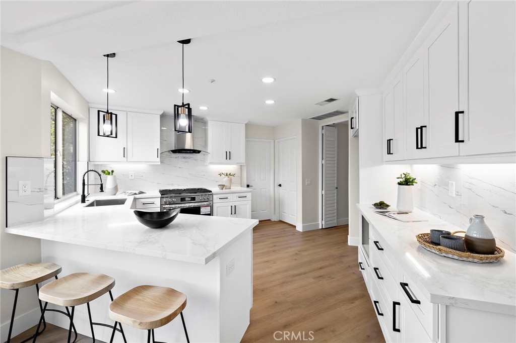 17 Rhode Island Irvine, CA 92606 - Photo 24 of 62 a kitchen with a sink a stove and chairs