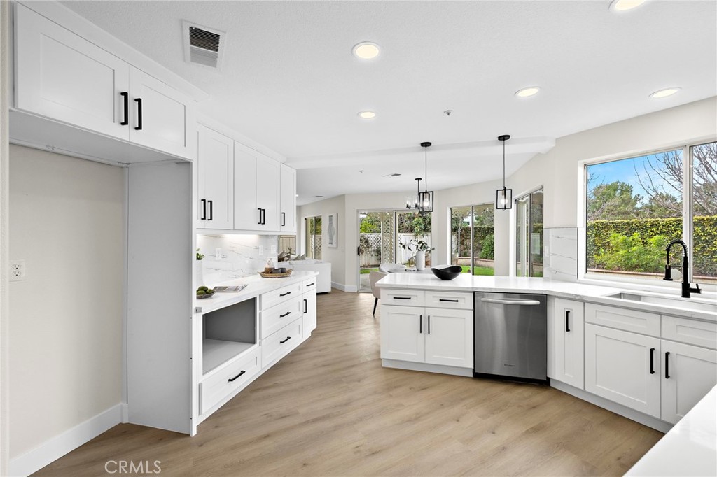 17 Rhode Island Irvine, CA 92606 - Photo 26 of 62 a large white kitchen with a stove top oven sink and cabinets