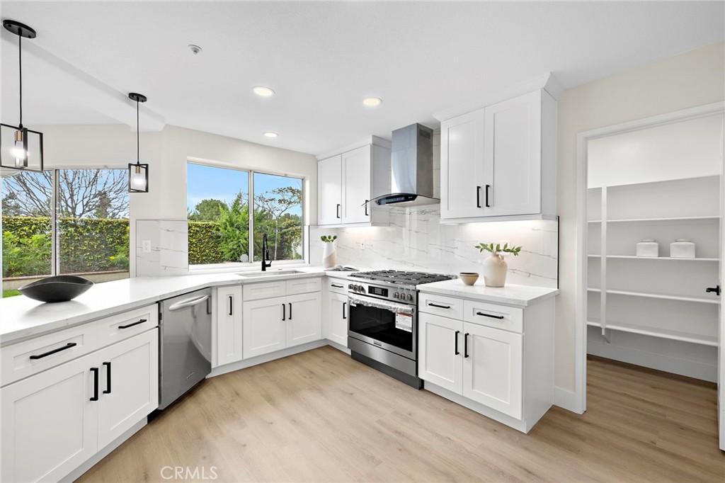 17 Rhode Island Irvine, CA 92606 - Photo 27 of 62 a kitchen with white cabinets and white appliances