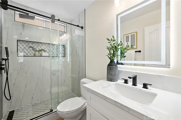 a spacious bedroom with two beds and a window