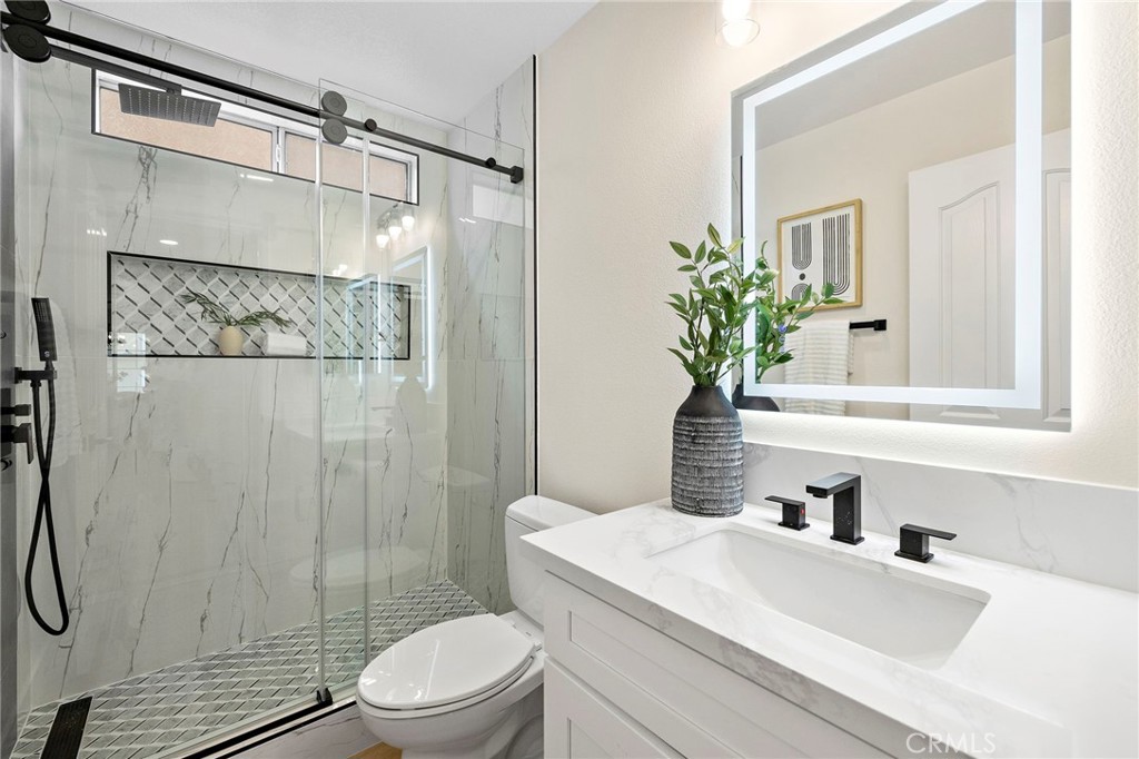 17 Rhode Island Irvine, CA 92606 - Photo 31 of 62 a bathroom with a sink a toilet and shower