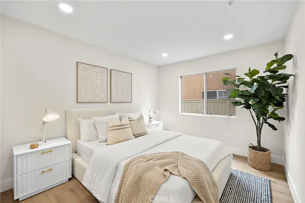 a bathroom with a sink and a mirror white cabinets