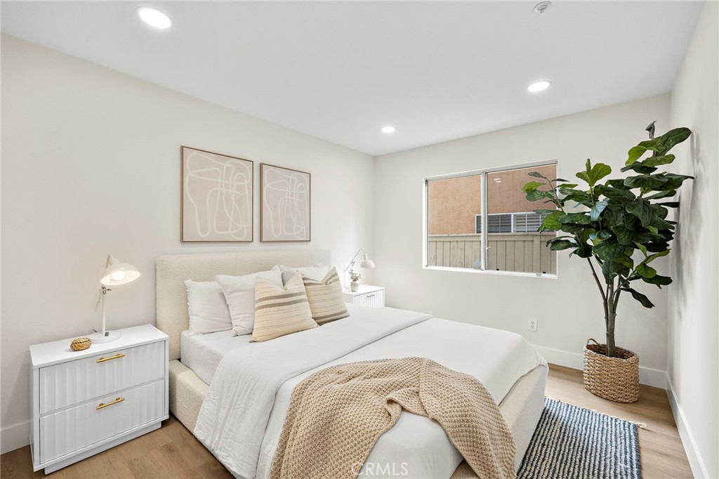 17 Rhode Island Irvine, CA 92606 - Photo 32 of 62 a bedroom with a bed and a potted plant