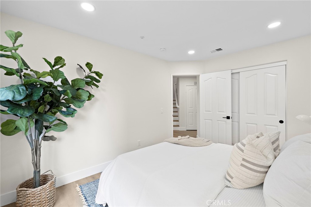 17 Rhode Island Irvine, CA 92606 - Photo 33 of 62 a bedroom with a bed and a potted plant