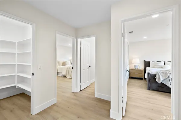 a spacious bedroom with a bed and a lamp