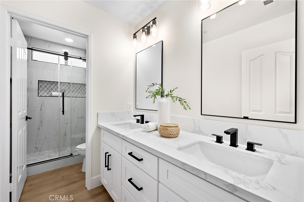 17 Rhode Island Irvine, CA 92606 - Photo 39 of 62 a bathroom with a sink and a mirror white cabinets
