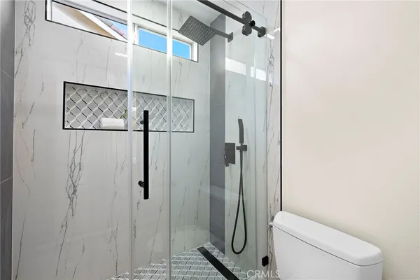 a spacious bedroom with a bed and a potted plant