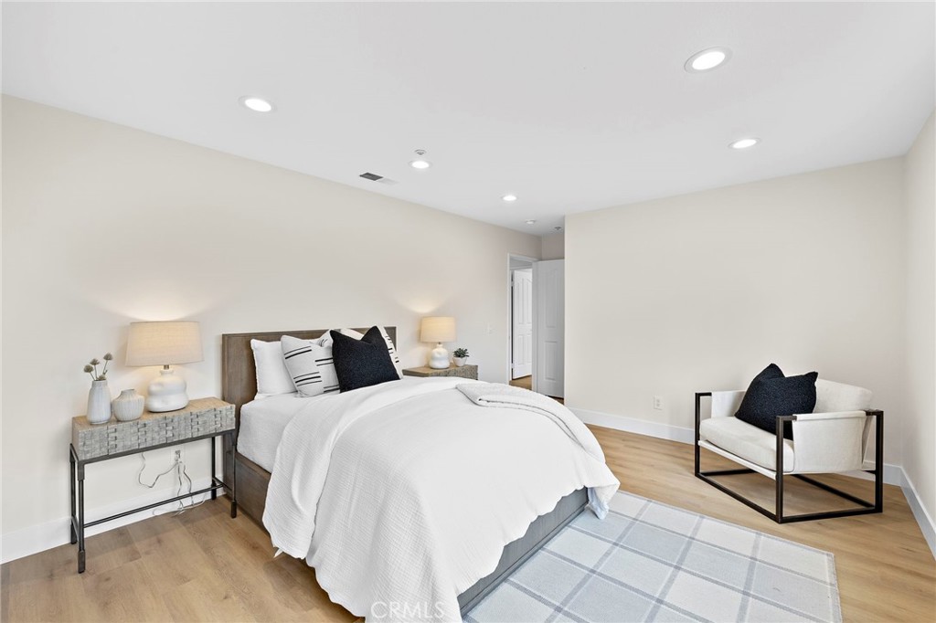 17 Rhode Island Irvine, CA 92606 - Photo 44 of 62 a spacious bedroom with a bed and a lamp