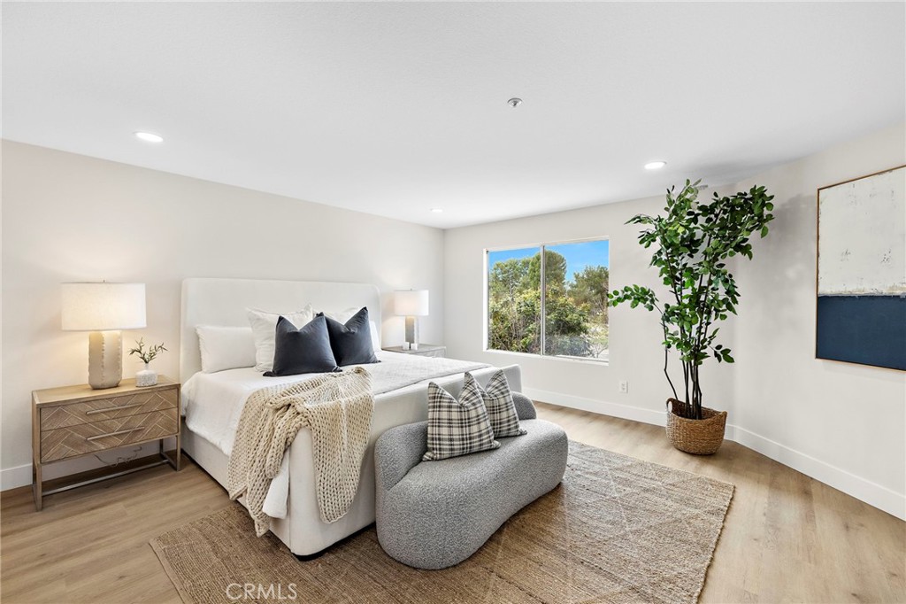 17 Rhode Island Irvine, CA 92606 - Photo 45 of 62 a bedroom with a bed and a potted plant