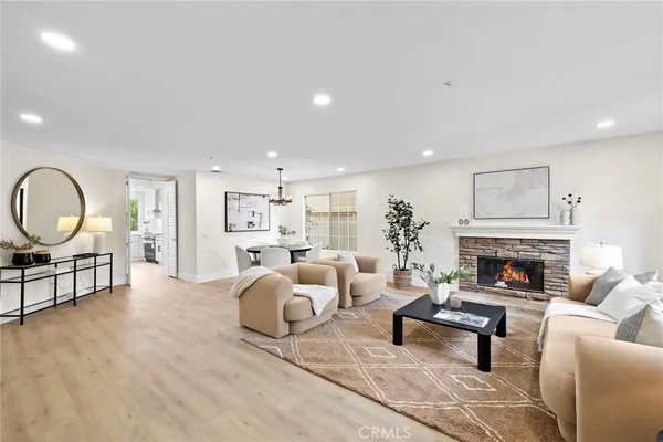 a spacious bedroom with a bed a couch and a large window