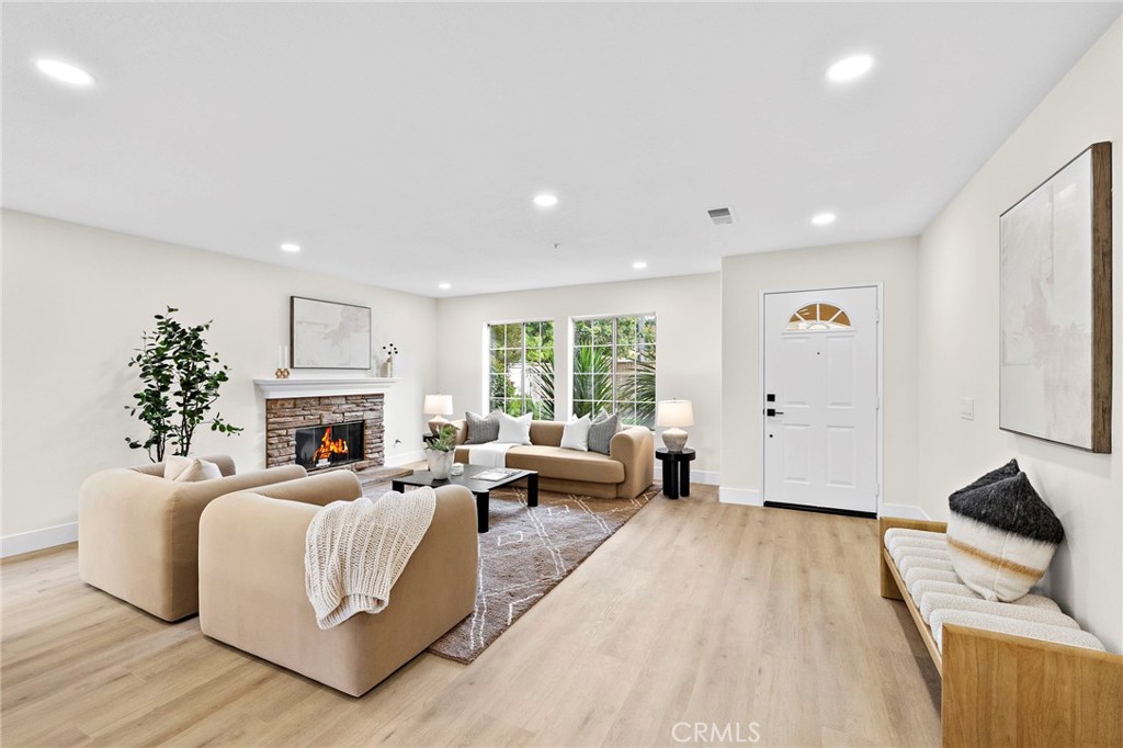 17 Rhode Island Irvine, CA 92606 - Photo 9 of 62 a spacious bedroom with a bed a couch and a large window