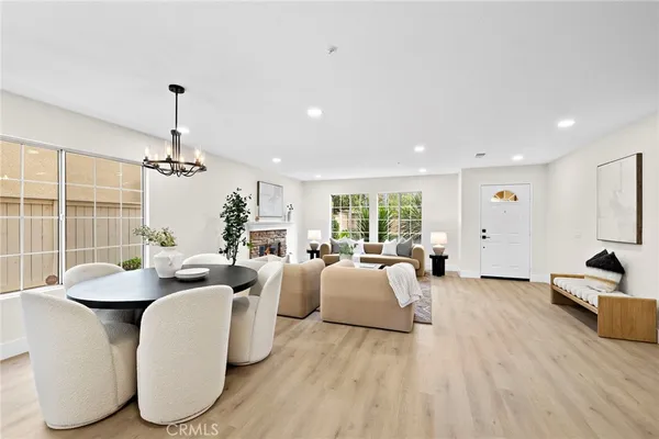 a living room with furniture a chandelier and a large mirror