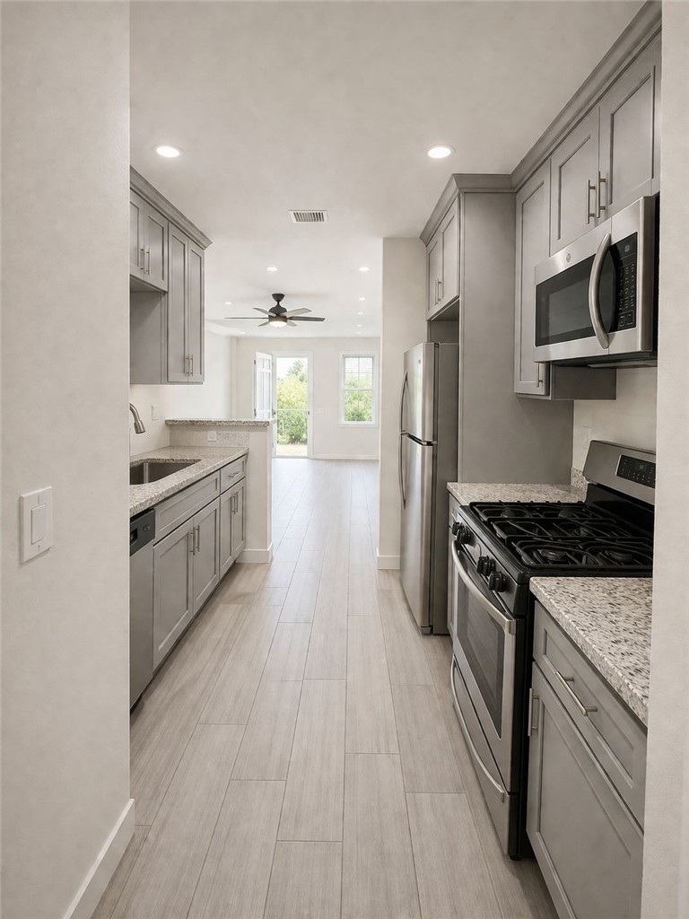 309 Alhambra Road Alhambra, CA 91801 - Photo 2 of 10 a kitchen with stainless steel appliances granite countertop a stove top oven a sink dishwasher a refrigerator and cabinets with wooden floor