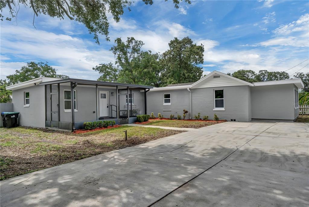 325 North Pine Hills Road Orlando, FL 32811 - Photo 1 of 1 a house with a yard and a large tree