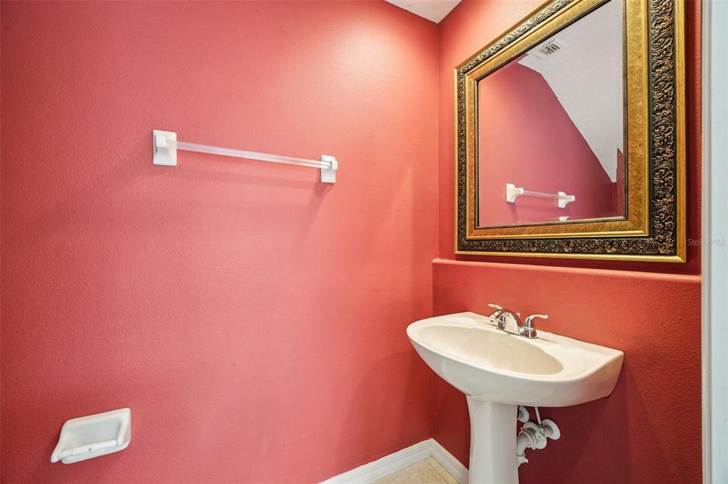 551 Terrace Spring Drive Orlando, FL 32828 - Photo 28 of 41 a bathroom with a sink and a mirror