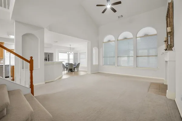 a dining room with furniture a chandelier and window