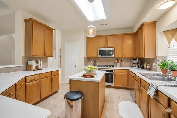 a kitchen with a sink stove and cabinets