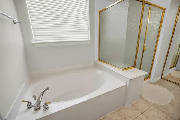 a bedroom with a bed and a ceiling fan