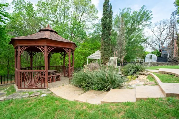 a view of table and chairs under an umbrella