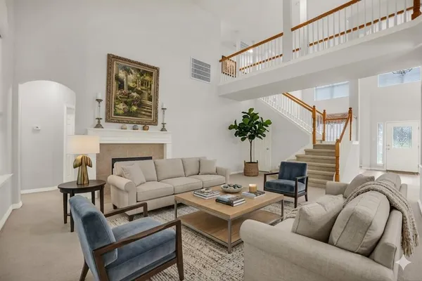 a view of an empty room with stairs and a fireplace