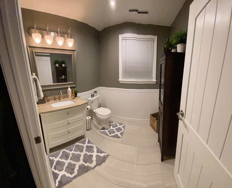 16 Bacon Road Framingham, MA 01701 - Photo 18 of 30 a bathroom with a bathtub sink and mirror
