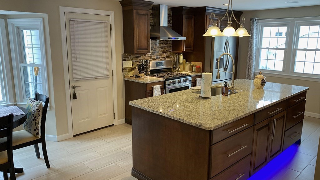 16 Bacon Road Framingham, MA 01701 - Photo 3 of 30 a kitchen with granite countertop cabinets and a stove