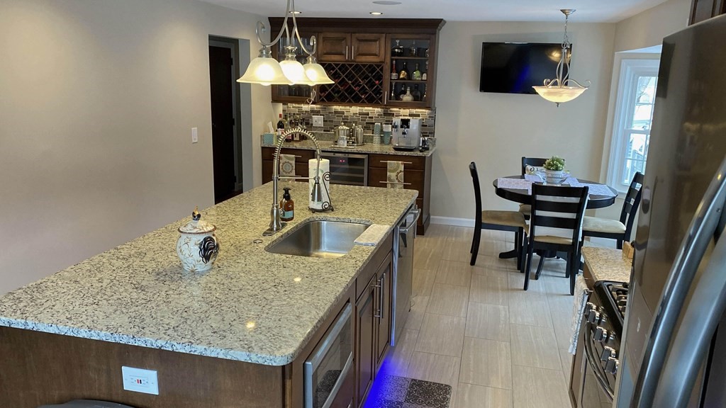 16 Bacon Road Framingham, MA 01701 - Photo 4 of 30 a kitchen with stainless steel appliances granite countertop a sink a stove and refrigerator