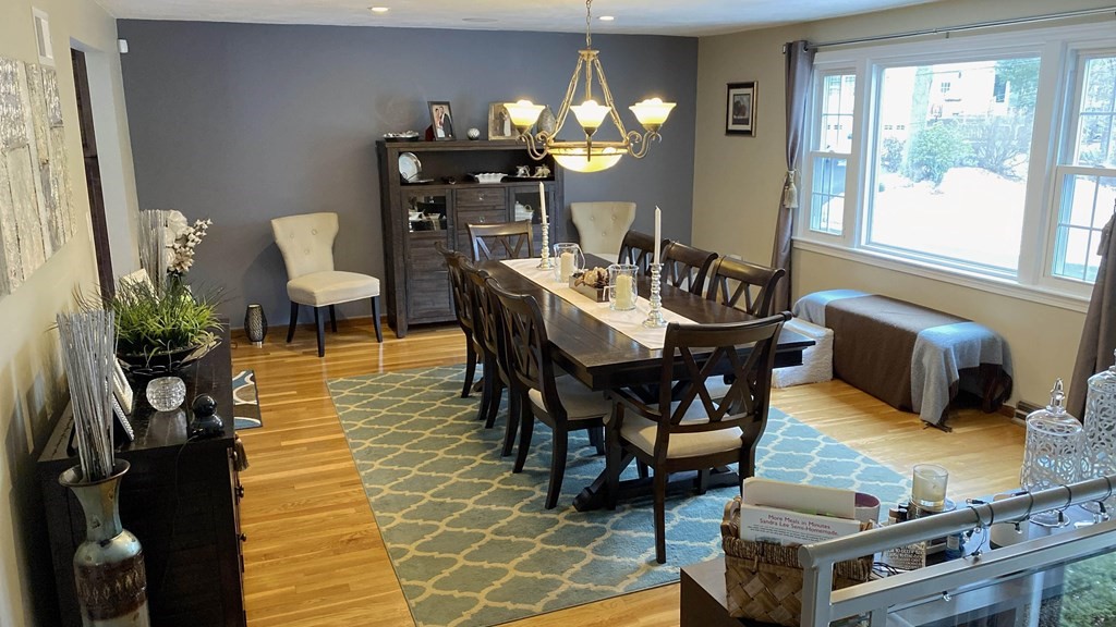 16 Bacon Road Framingham, MA 01701 - Photo 6 of 30 a dining room with furniture a rug a potted plant and a fireplace