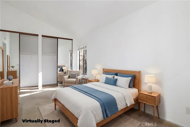 a bedroom with a bed and a night stand