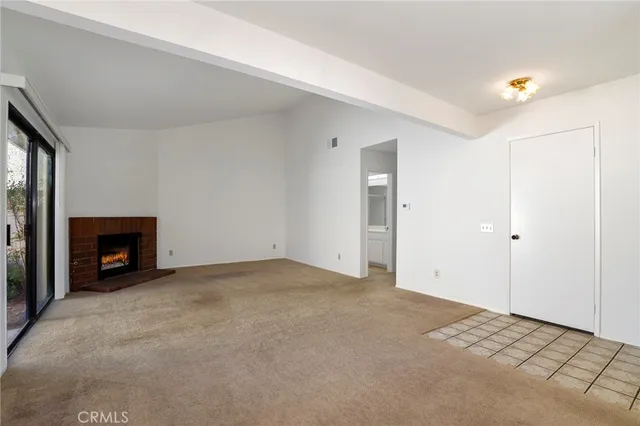 an empty room with a fireplace