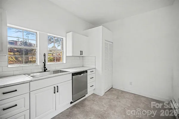 a kitchen with a sink cabinets and window