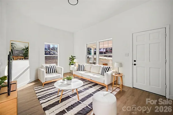 a living room with furniture and wooden floor