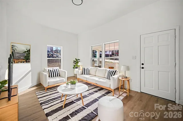 a living room with furniture and wooden floor