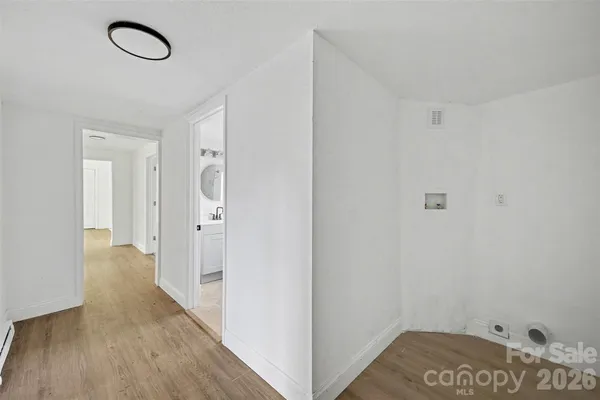 a view of a room with wooden floor