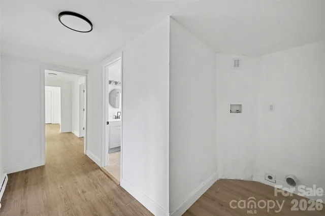 a view of a room with wooden floor