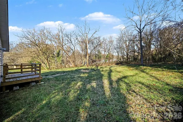 a view of a yard with large trees