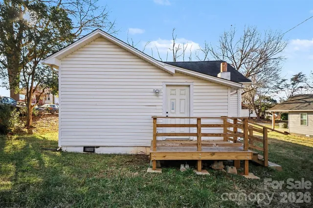 a view of a house with a wooden fence