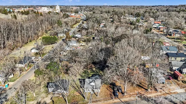 a view of a house with a yard covered in snow