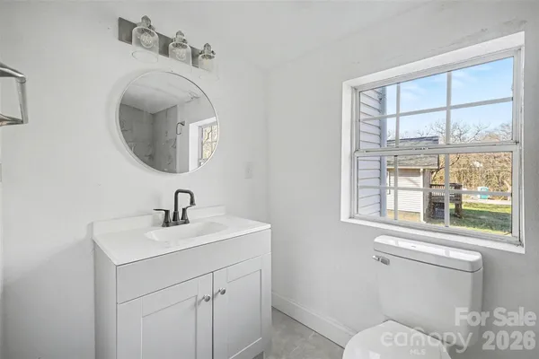 a bathroom with a toilet a sink and a mirror