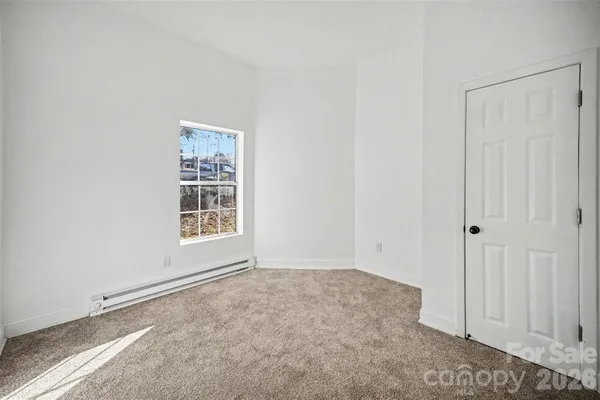 an empty room with a empty space and a window