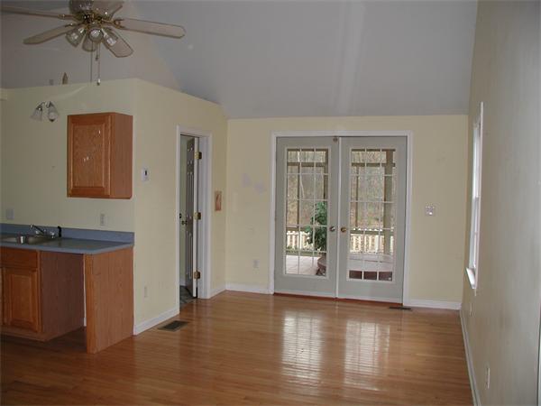 71 Harvard Road Shirley, MA 01464 - Photo 8 of 28 an empty room with wooden floor and windows