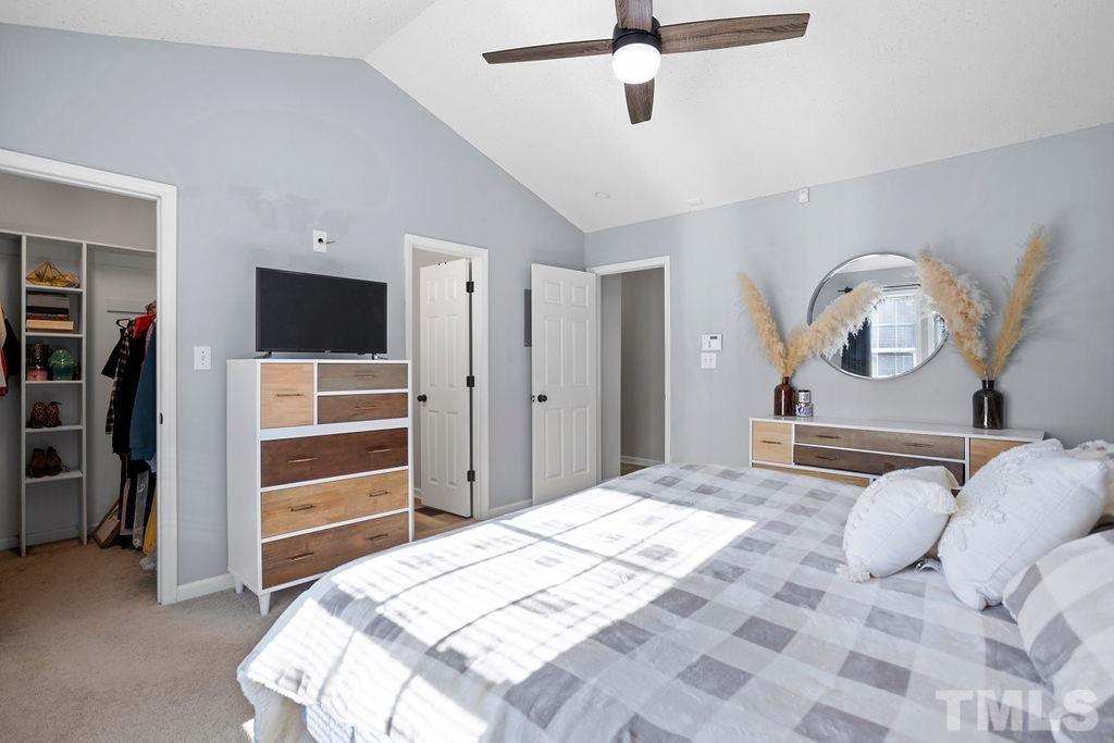 7929 Flower Hill Road Middlesex, NC 27557 - Photo 13 of 28 a bedroom with a bed and a ceiling fan