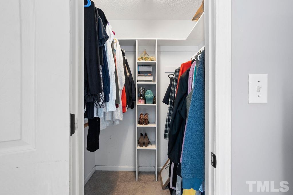 7929 Flower Hill Road Middlesex, NC 27557 - Photo 14 of 28 a view of walk in closet with clothes
