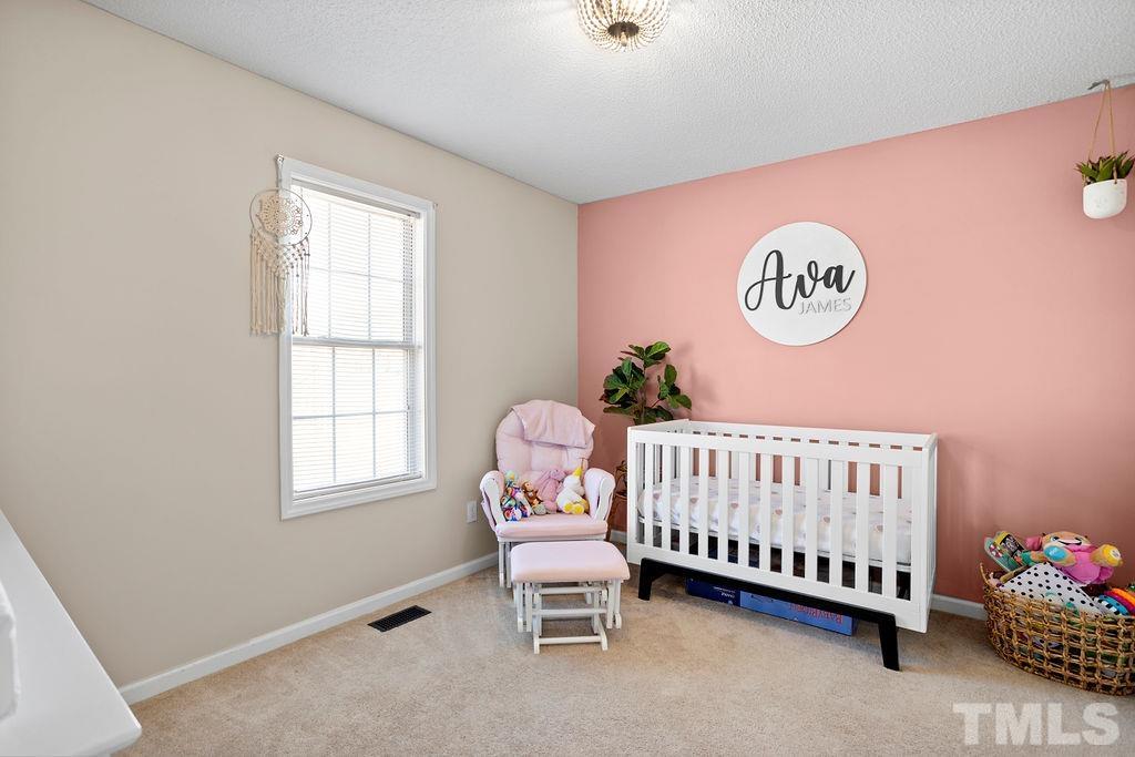 7929 Flower Hill Road Middlesex, NC 27557 - Photo 16 of 28 a bedroom with a bed and a window