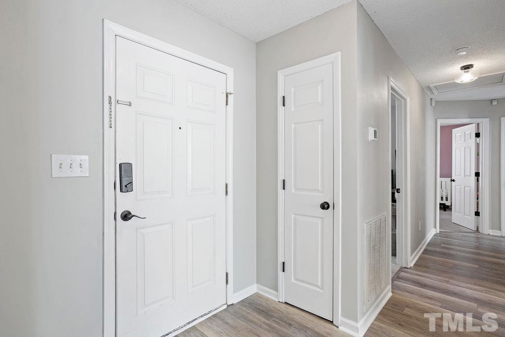 7929 Flower Hill Road Middlesex, NC 27557 - Photo 21 of 28 a view of a hallway with wooden floor and closet area