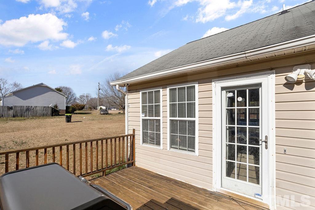 7929 Flower Hill Road Middlesex, NC 27557 - Photo 22 of 28 a view of balcony with wooden floor and fence